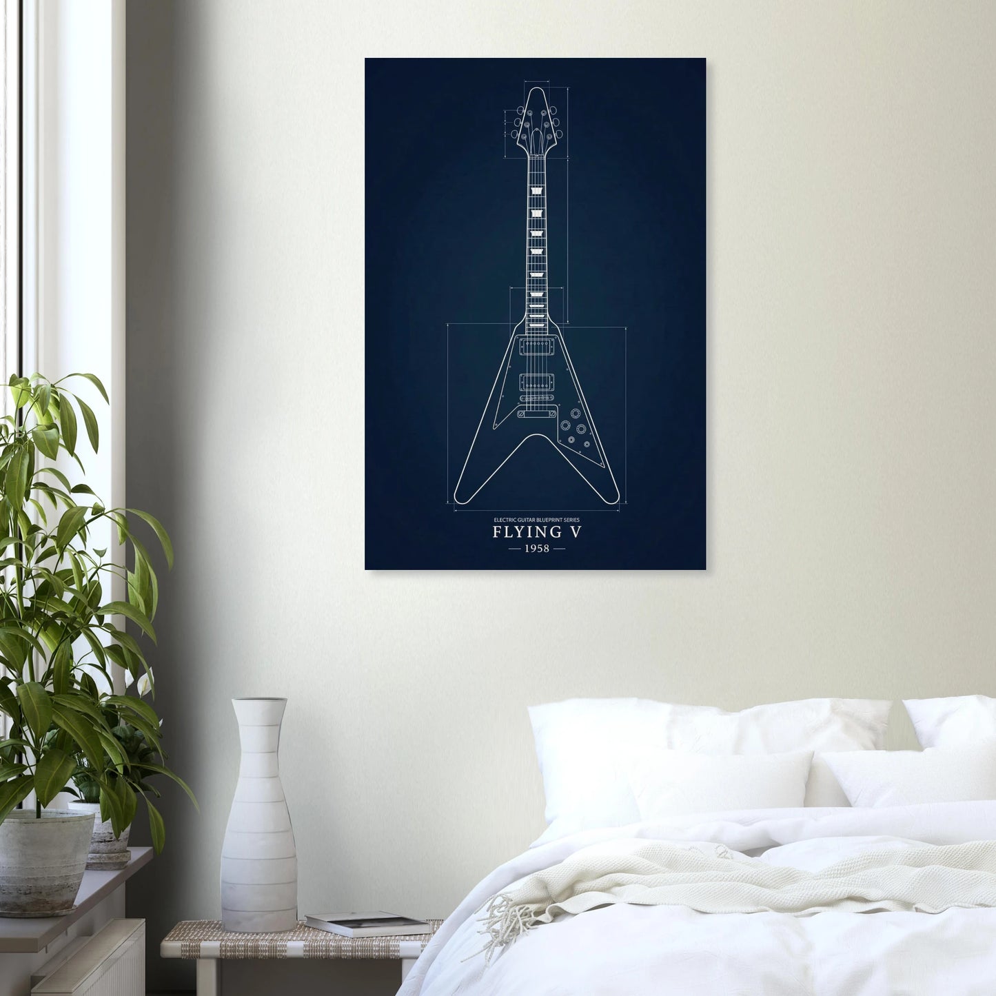 Gibson Flying V Blueprint art print in a black frame above a bed in a modern bedroom — Guitar Prints museum-quality matte art print