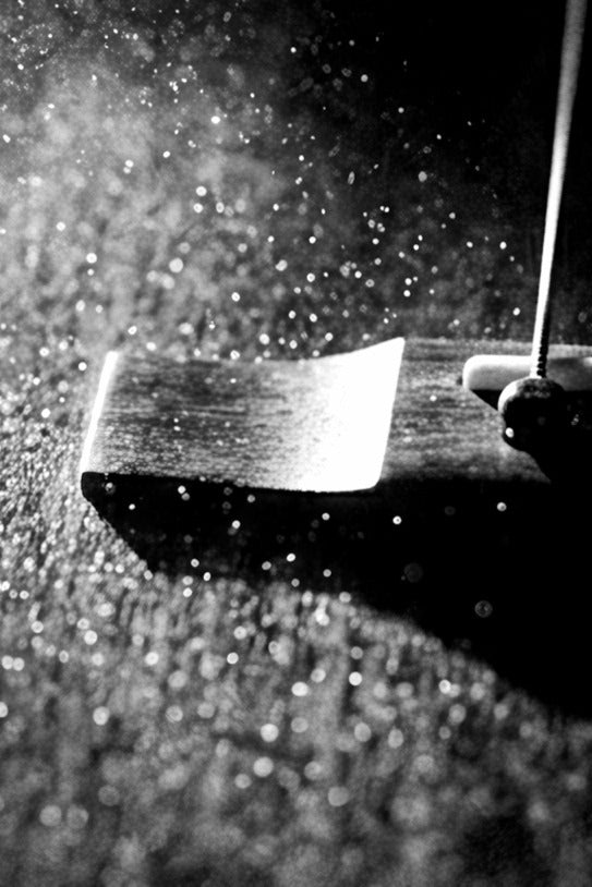 Close-up of dust falling onto an acoustic guitar