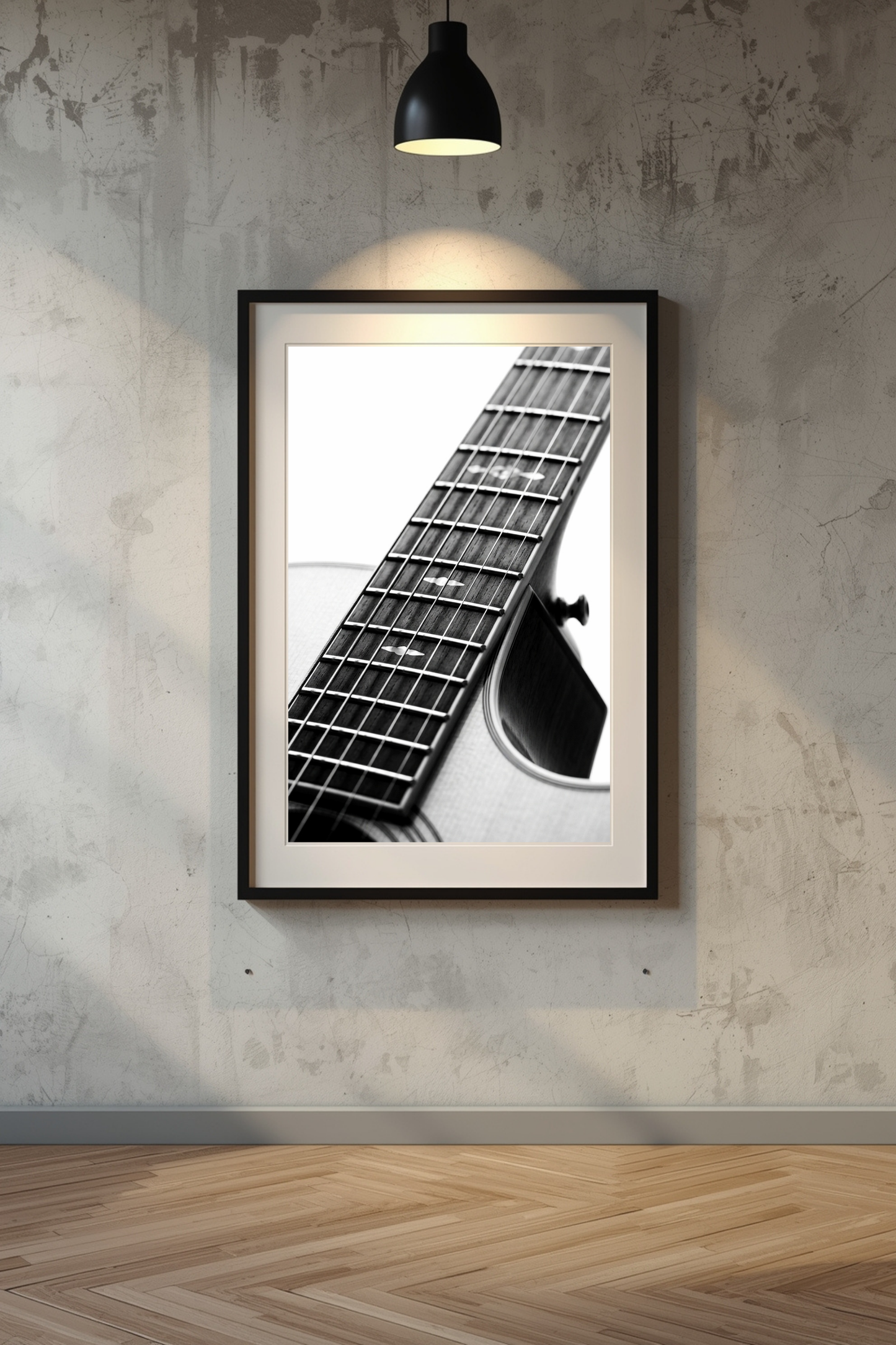 First Light acoustic guitar print framed in black on a concrete wall with spotlight — black and white acoustic guitar fretboard photography