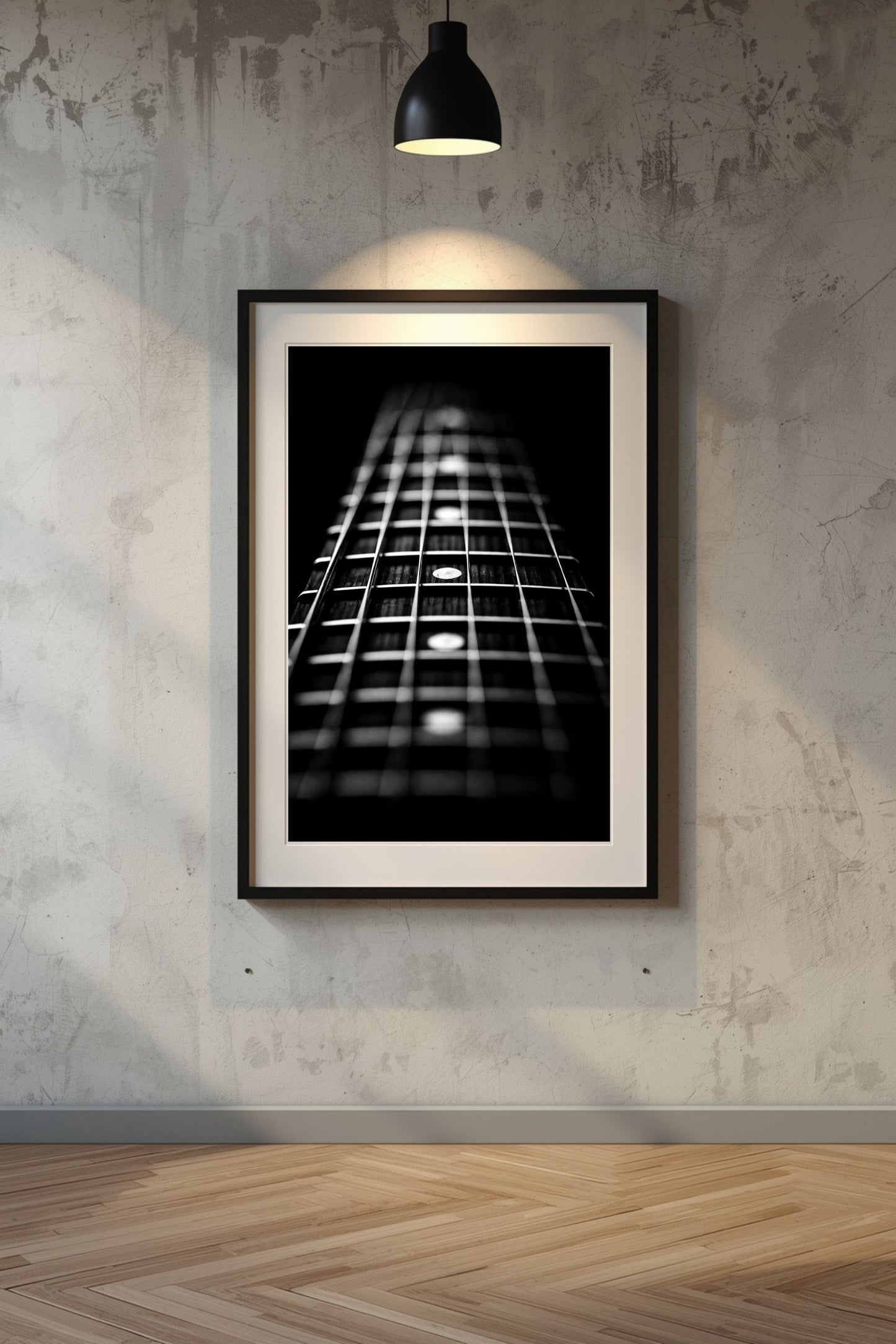 Framed black and white guitar neck print on a textured wall.