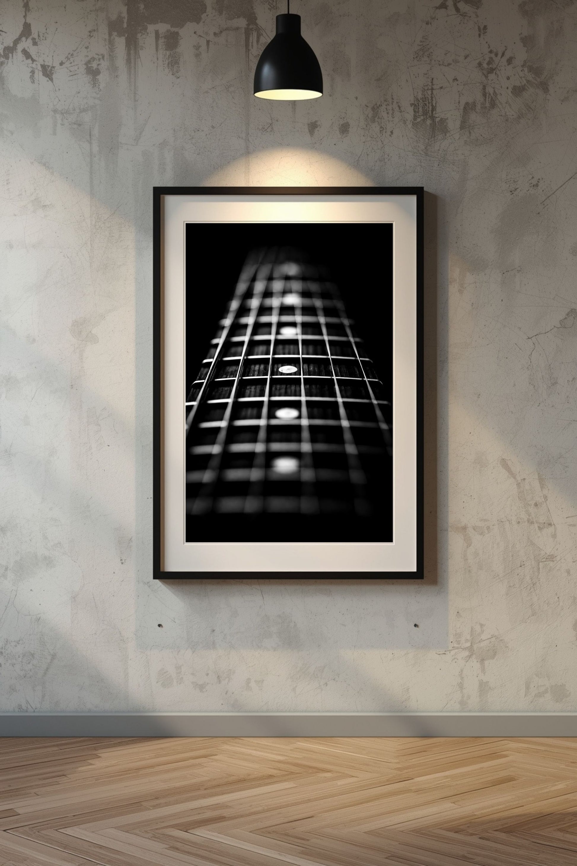 Framed black and white guitar neck print on a textured wall.