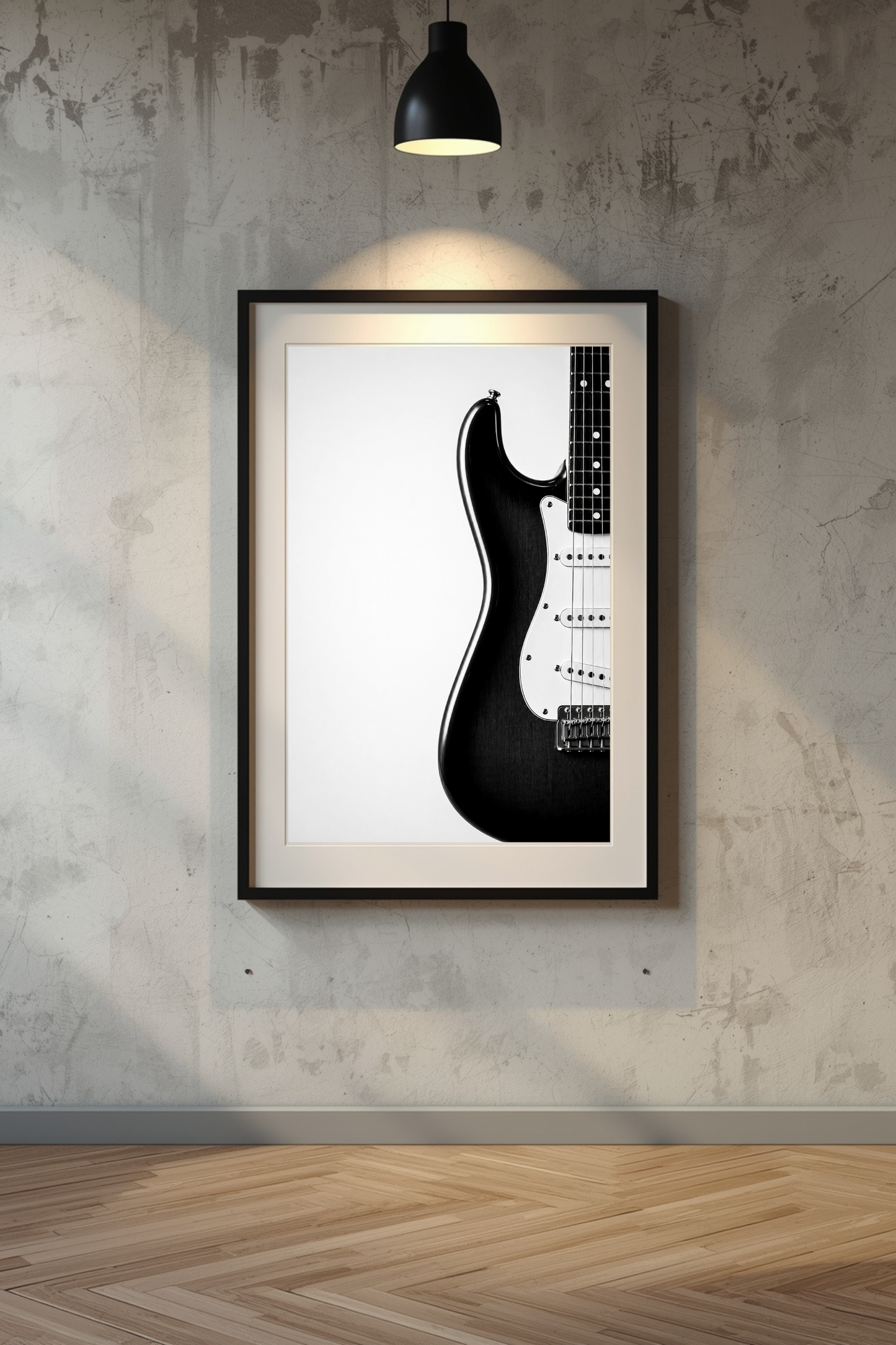Framed black and white Stratocaster guitar art print on a textured wall.