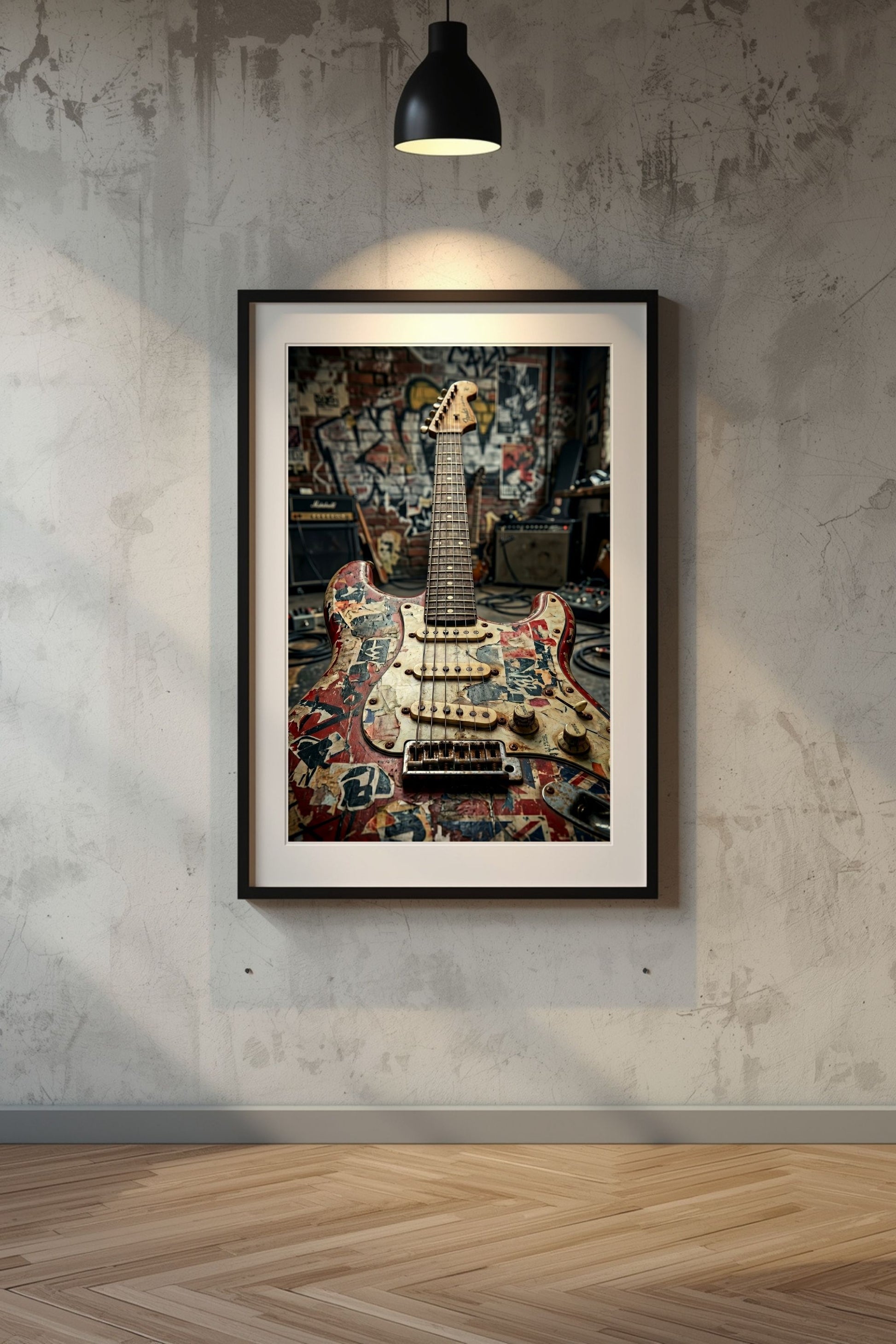 Framed artwork of a guitar on a textured wall with a lamp above.