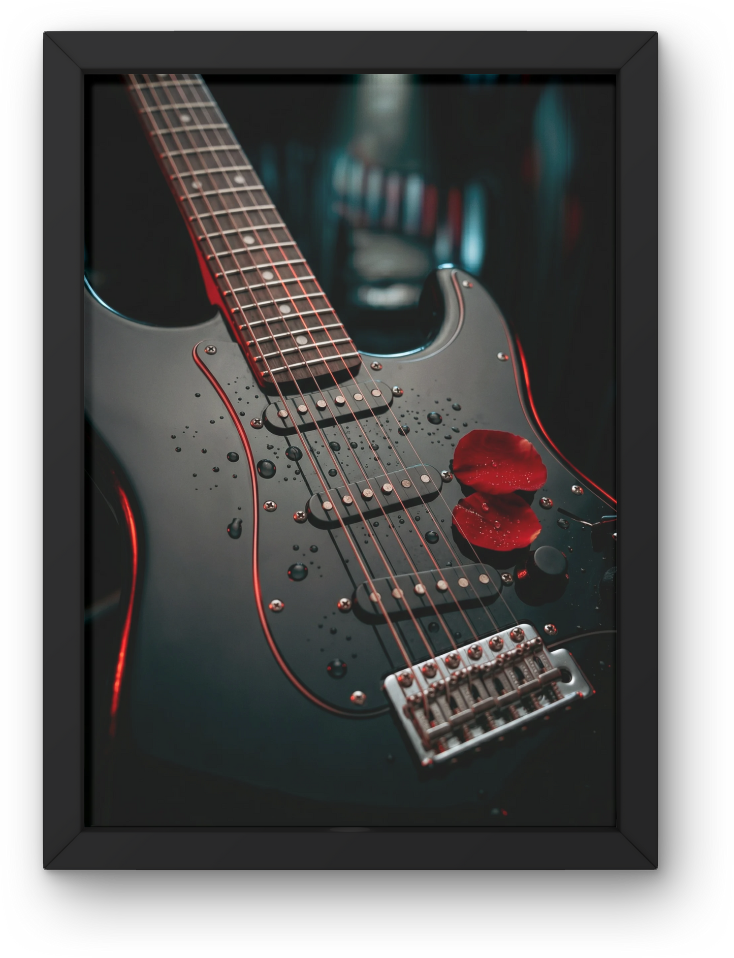 Framed photograph of a black electric guitar with red accents on a dark background