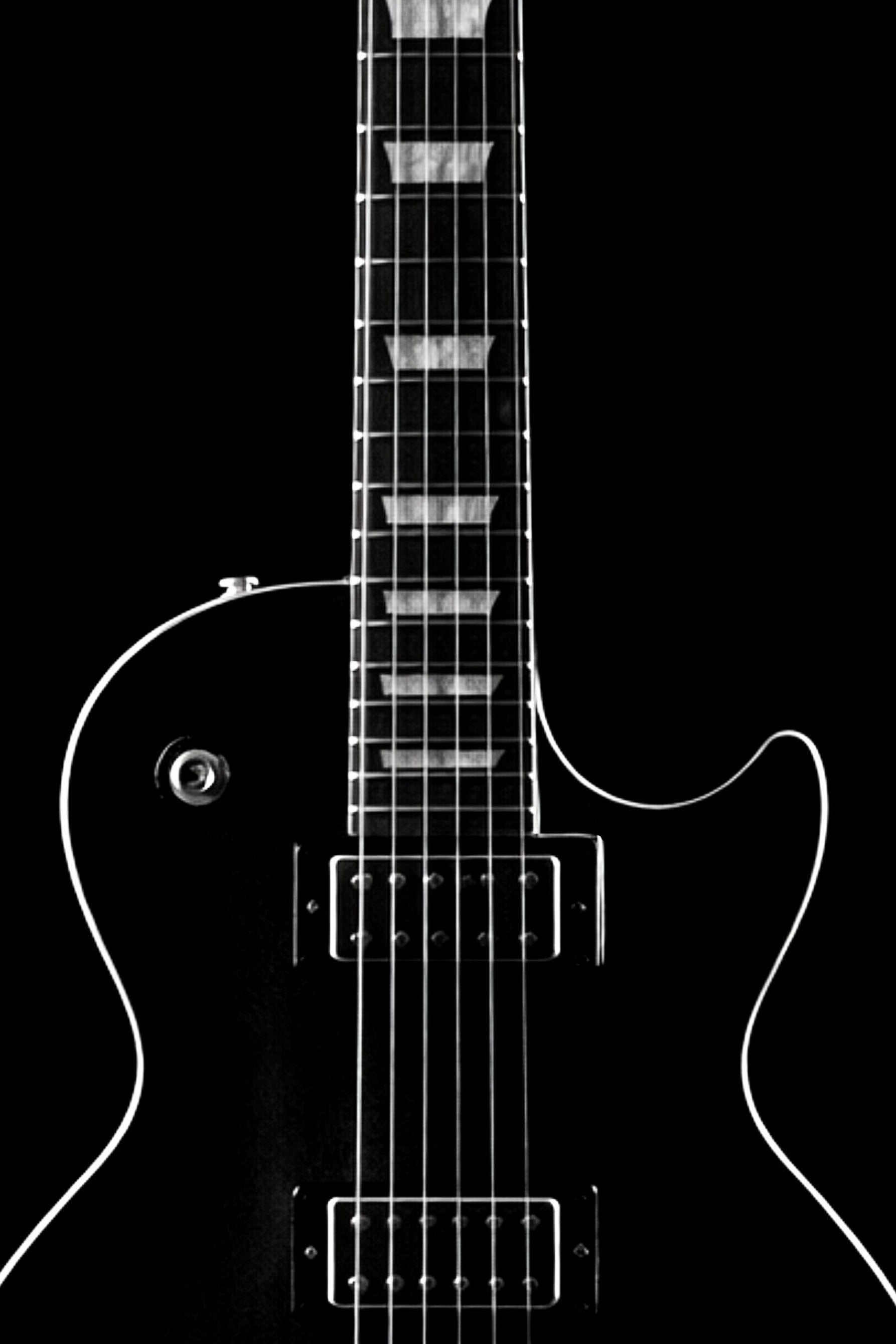 Black and white image of a guitar with a clear outline on a black background