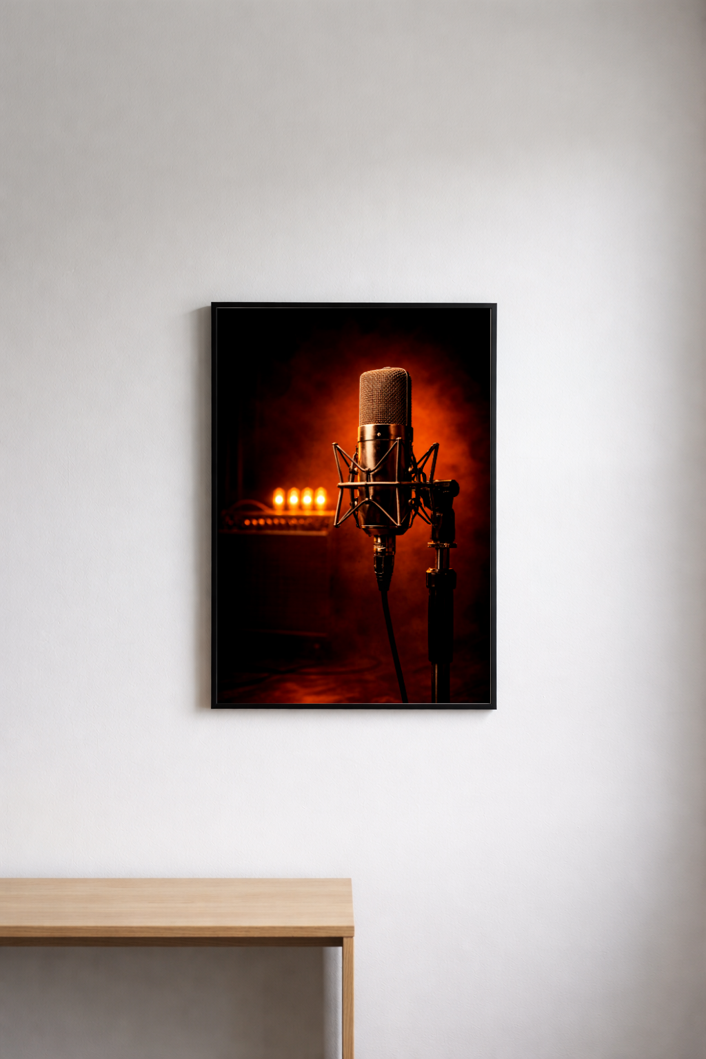 Framed picture of a microphone on a wall above a wooden surface