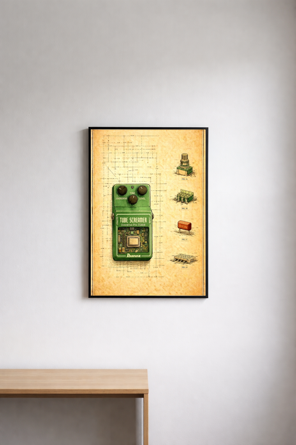 Framed artwork of an Ibanez tube screamer on a beige background, mounted on a white wall.