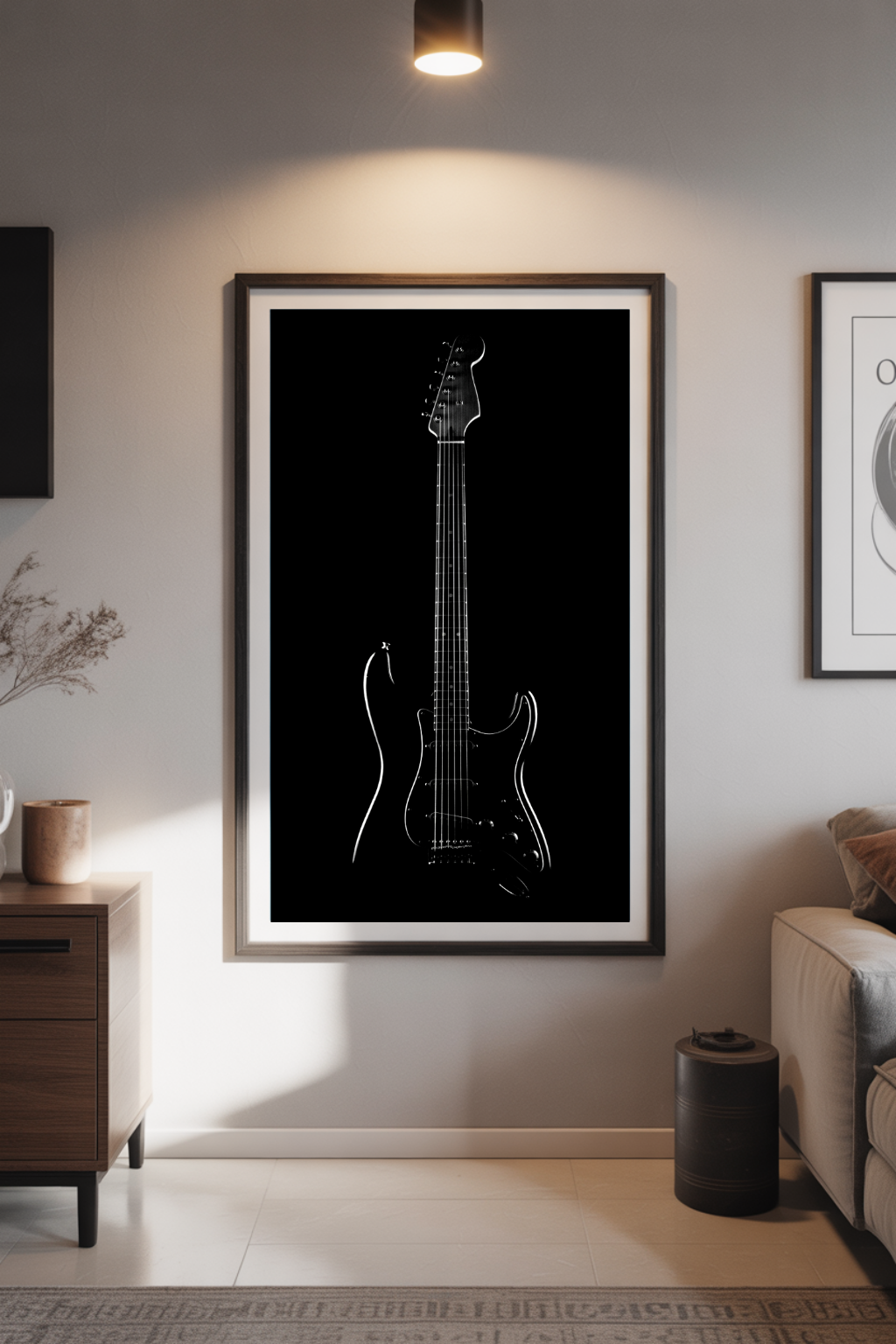 Framed black and white guitar art print on a wall in a living room.