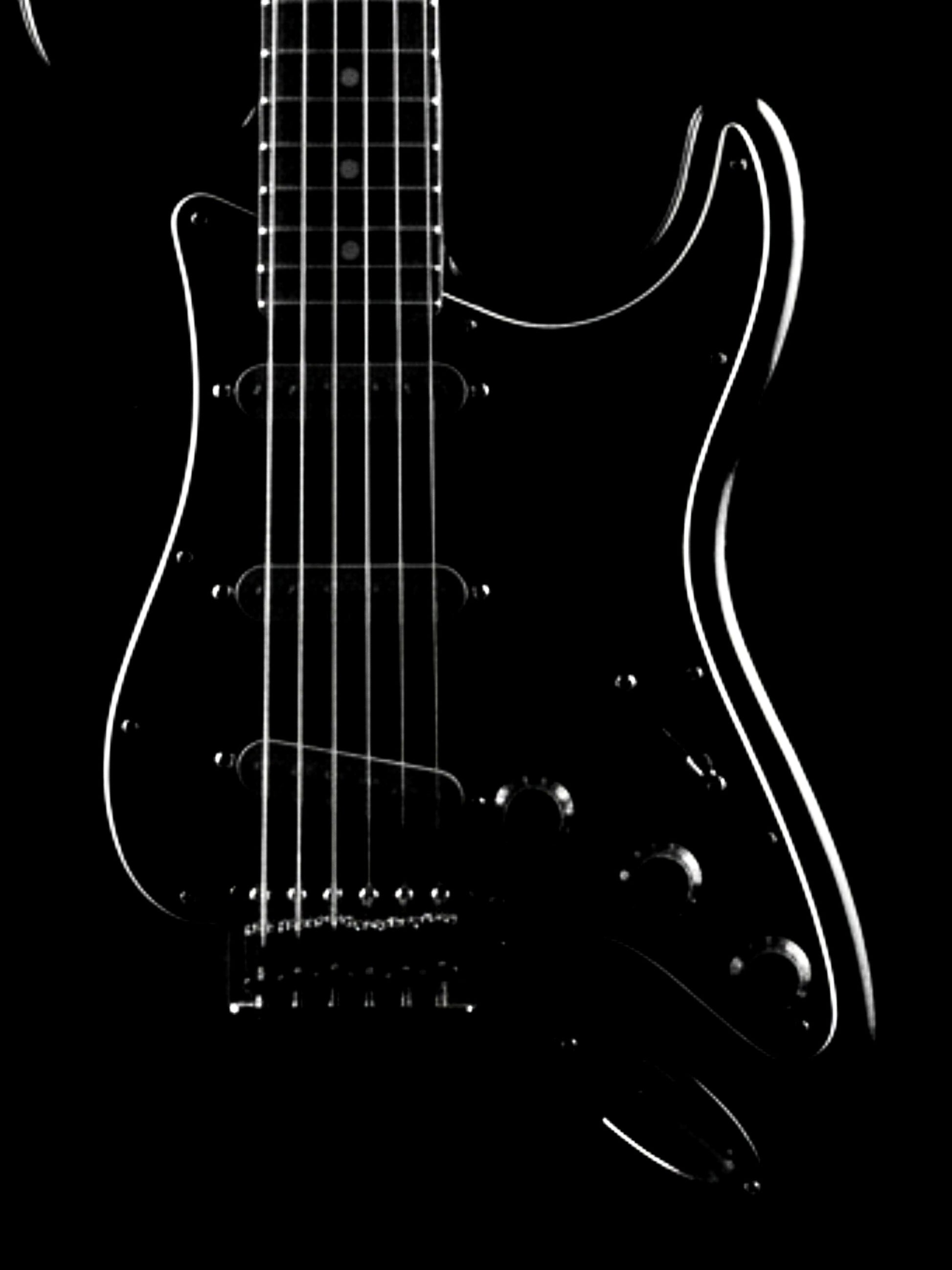 Black electric guitar with a white outline on a black background