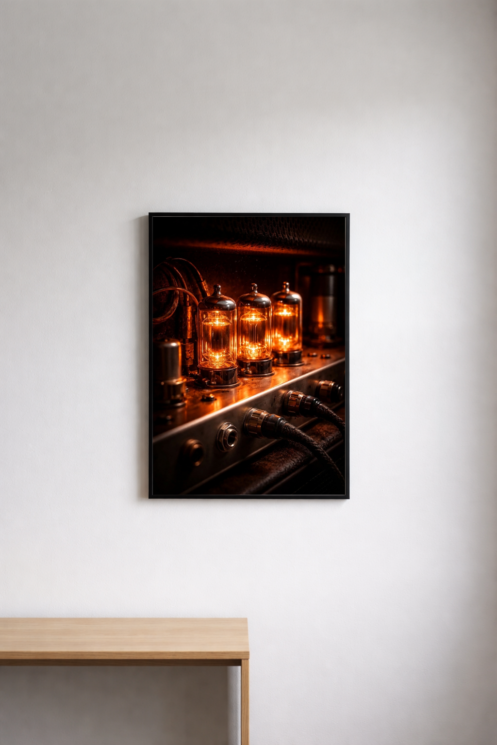 Framed photograph of tube amp valves against a white wall.